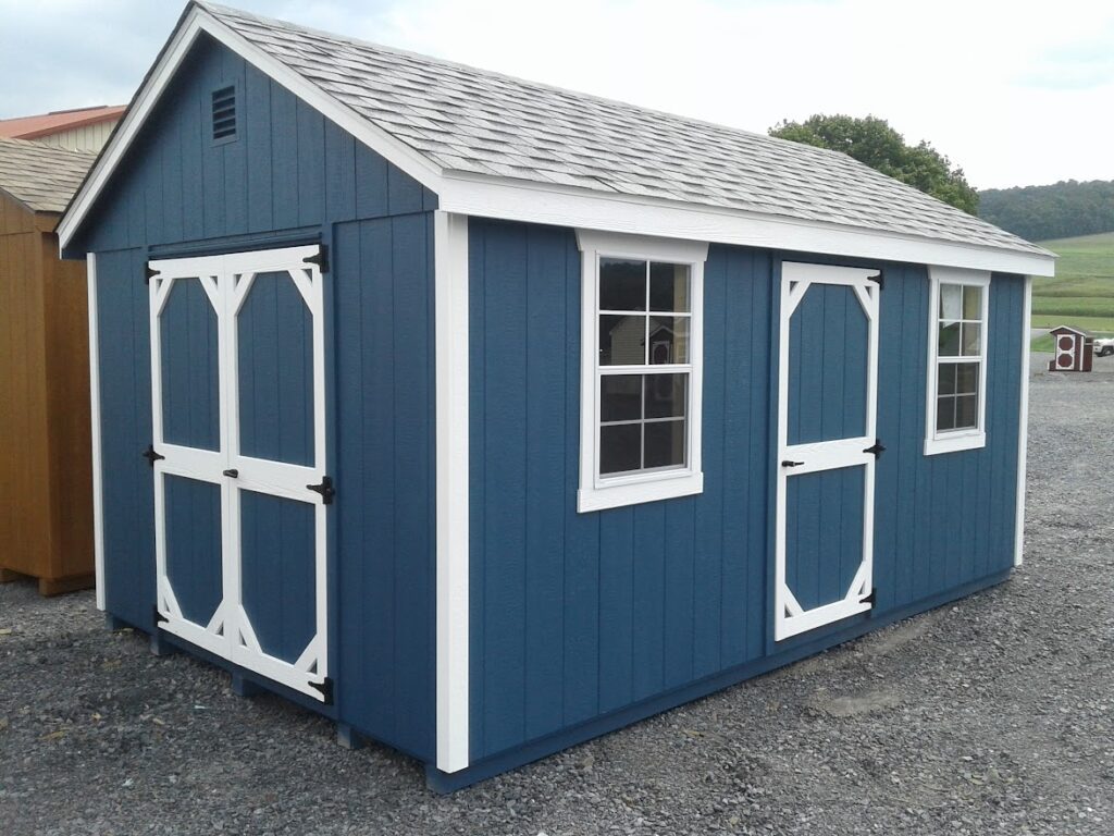 blue a-frame shed with white trim
