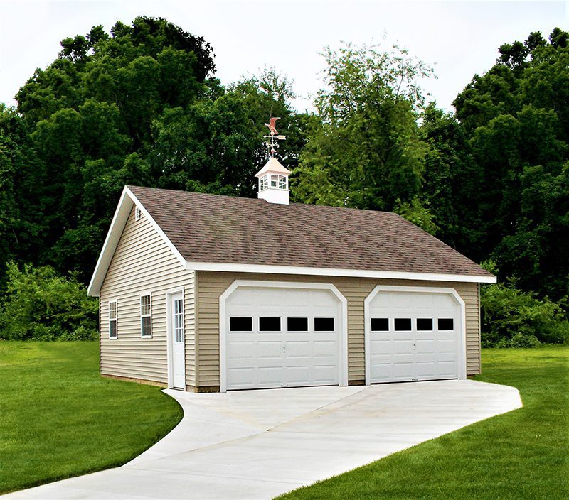 a two-car garage with a cupola on top