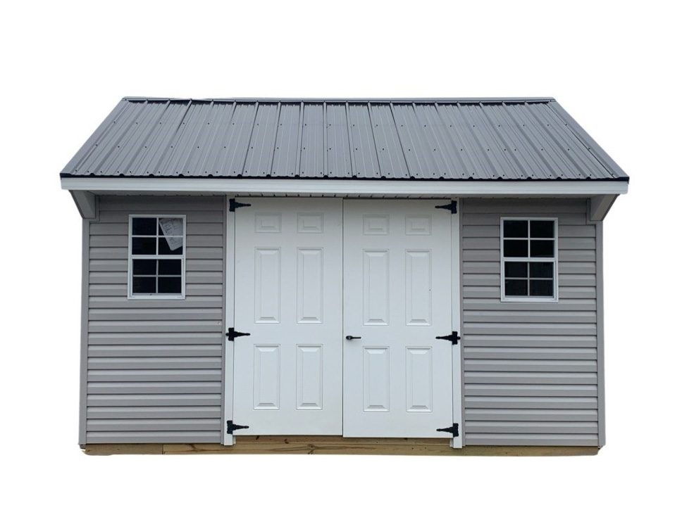 gray shed with white doors