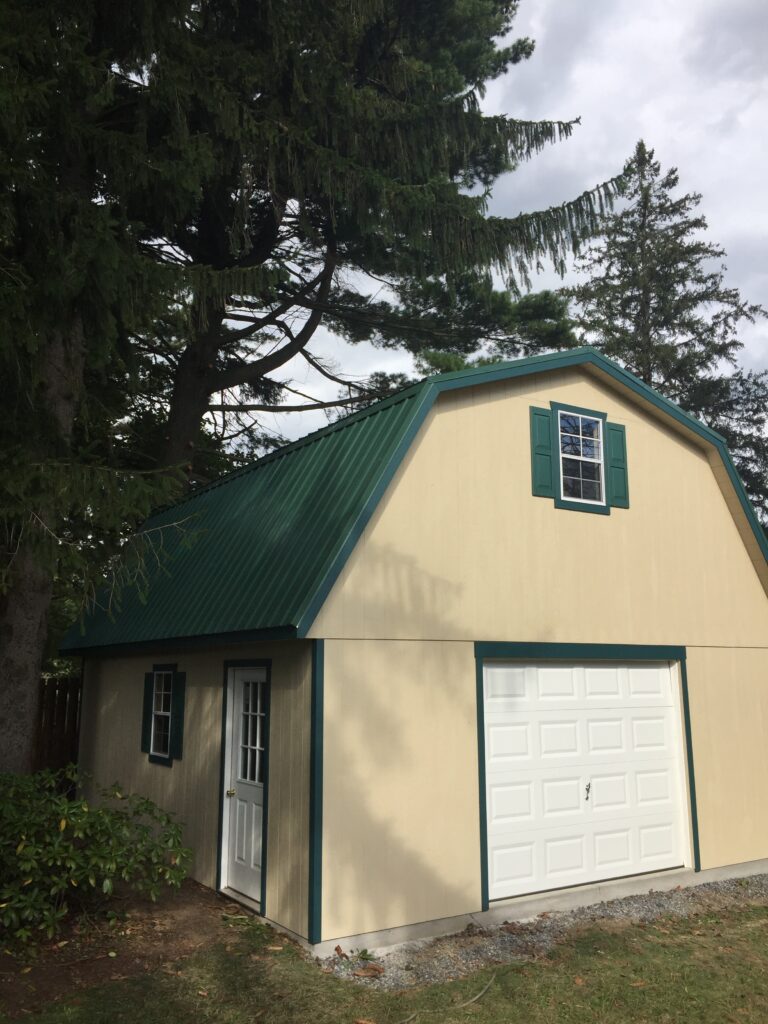 green and tan barn style garage