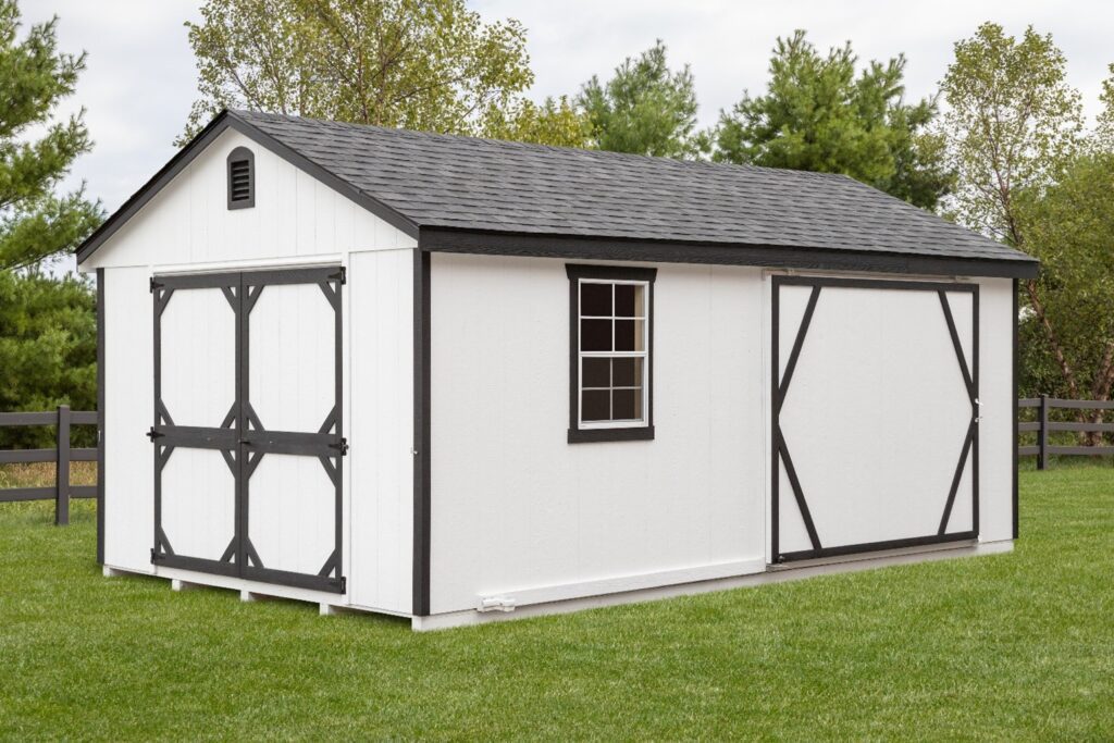 a white shed with gray tirm